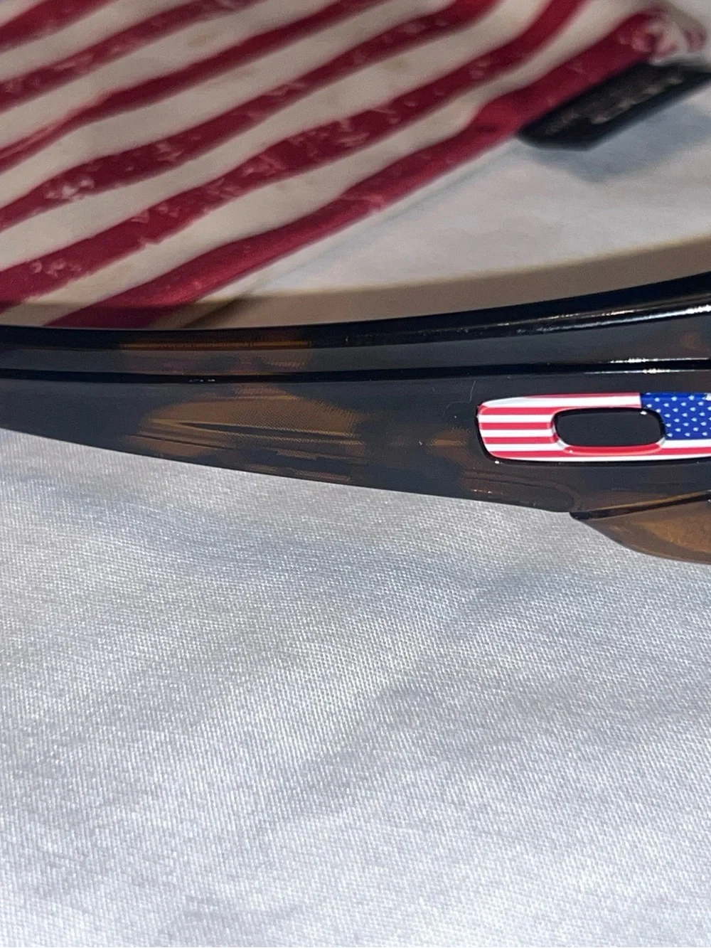 Oakley Tortoise Frame Sunglasses with Blue Lenses and American Flag Accent